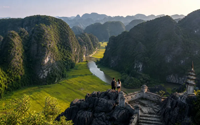 Travellers on the Hang Mua peak looking over the Tam Coc river valley