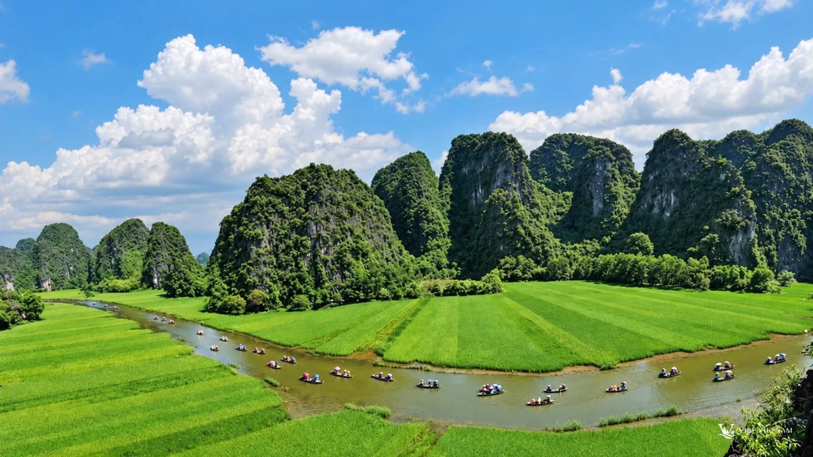 Green rice fields, a river and limestone karst hills in the Tam Coc valley