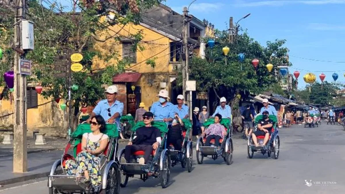 Travellers on a cyclo ride through Hoi An Ancient Town