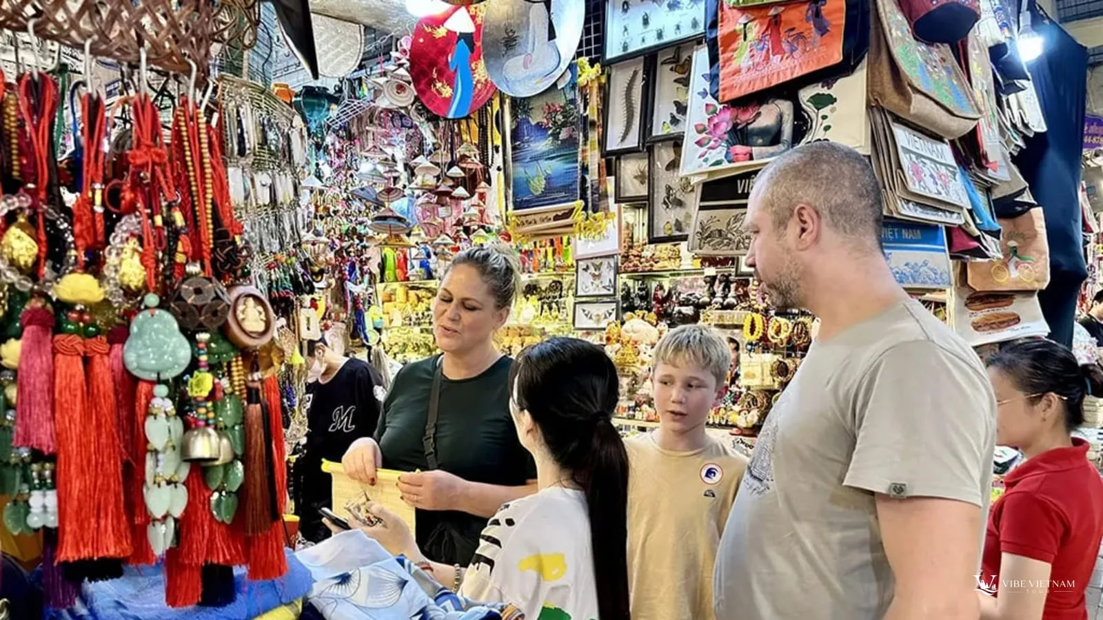 Visitors buying souvenirs at a market in Vietnam