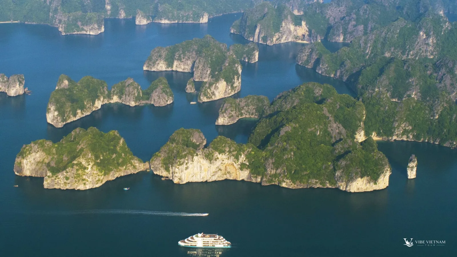Limestone islands and a cruise boat in Lan Ha Bay